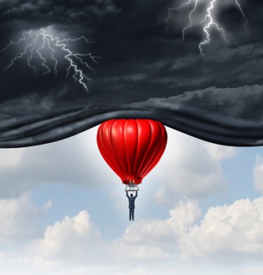 38697310 - positive outlook and recovery concept as a person or businessman riding a red hot air balloon lifting the dangerous dark stormy skies to reveal a bright warm blue sky as a mindset symbol of managing economic or emotional perception.